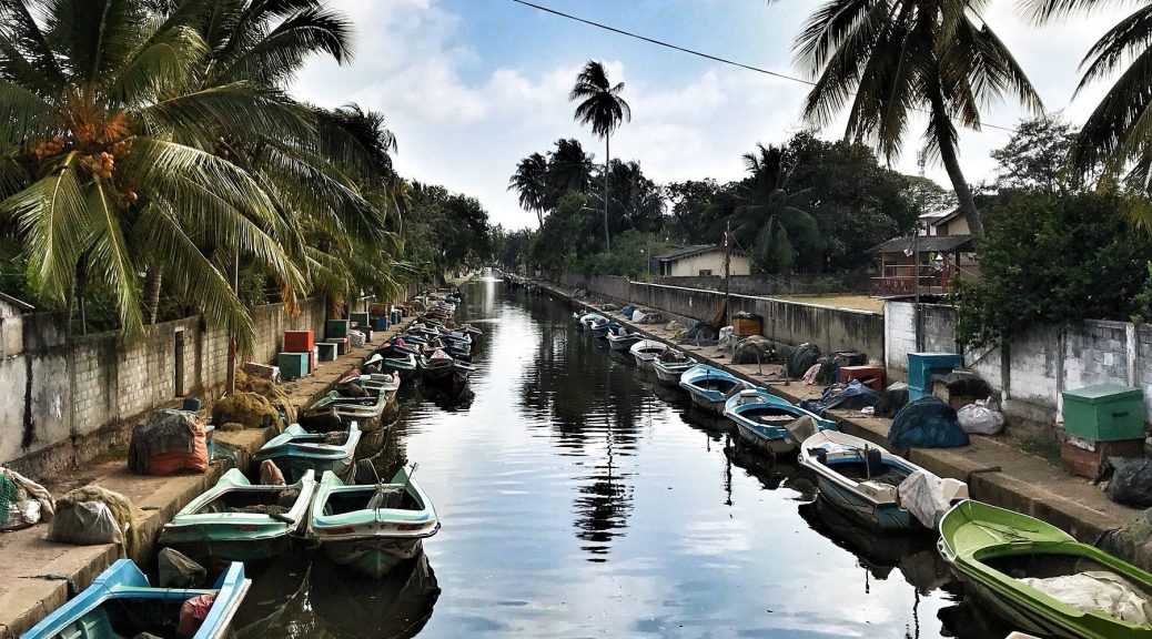 “Historic Dutch Port and tranquil canal in Sri Lanka, featuring colonial-era architecture, calm waters, and lush greenery.”