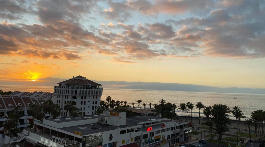 "Nighttime view from H10 Las Palmeras hotel, featuring a beautifully illuminated cityscape with palm trees and distant lights creating a serene and vibrant atmosphere."